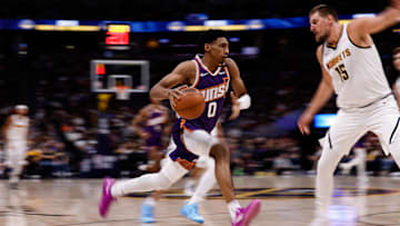 Oct 13, 2024; Denver, Colorado, USA; Phoenix Suns forward Ryan Dunn (0) controls the ball as Denver Nuggets center Nikola Jokic (15) defends in the second quarter at Ball Arena. Mandatory Credit: Isaiah J. Downing-Imagn Images