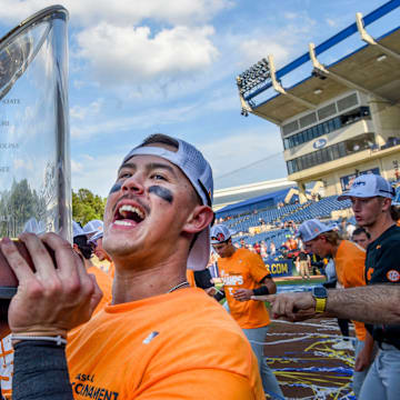 May 26 2024; Hoover, AL, USA; Tennessee outfielder Hunter Ensley (9) lifts the trophy in celebration at the Hoover Met following the championship game of the SEC Tournament. Tennessee held on to win 4-3.