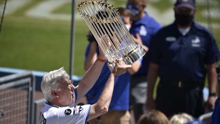 Los Angeles Dodgers part owner Mark Walter holds up the Commissioner's Trophy.