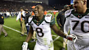 Oct 23, 2014; Blacksburg, VA, USA; Miami Hurricanes running back Duke Johnson (8) runs off the field with offensive lineman Jon Feliciano (70) at halftime at Lane Stadium. Mandatory Credit: Bob Donnan-Imagn Images