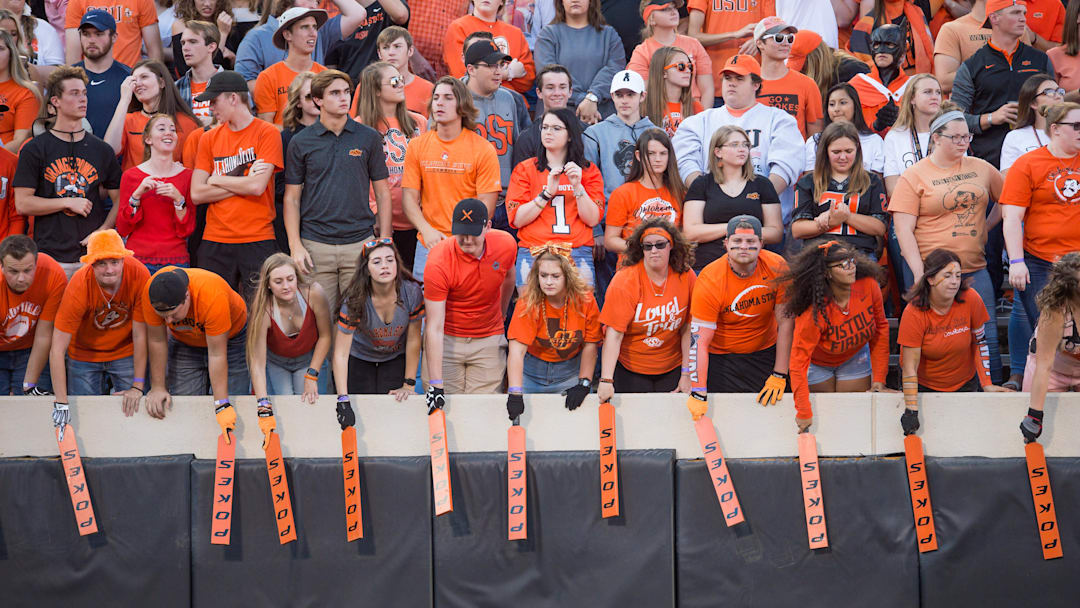 Sep 22, 2018; Stillwater, OK, USA;  Oklahoma State Cowboys paddle people hit the sides of the stands during the game against the Texas Tech Red Raiders at Boone Pickens Stadium. Texas Tech won the game 41-17. Mandatory Credit: Brett Rojo-Imagn Images