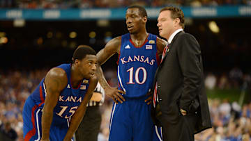 Apr 2, 2012; New Orleans, LA, USA; Kansas Jayhawks head coach Bill Self talks with guard Tyshawn Taylor (10) and guard Elijah Johnson (15) during the second half in the finals of the 2012 NCAA men's basketball Final Four against the Kentucky Wildcats at the Mercedes-Benz Superdome. 