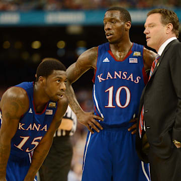 Apr 2, 2012; New Orleans, LA, USA; Kansas Jayhawks head coach Bill Self talks with guard Tyshawn Taylor (10) and guard Elijah Johnson (15) during the second half in the finals of the 2012 NCAA men's basketball Final Four against the Kentucky Wildcats at the Mercedes-Benz Superdome. 