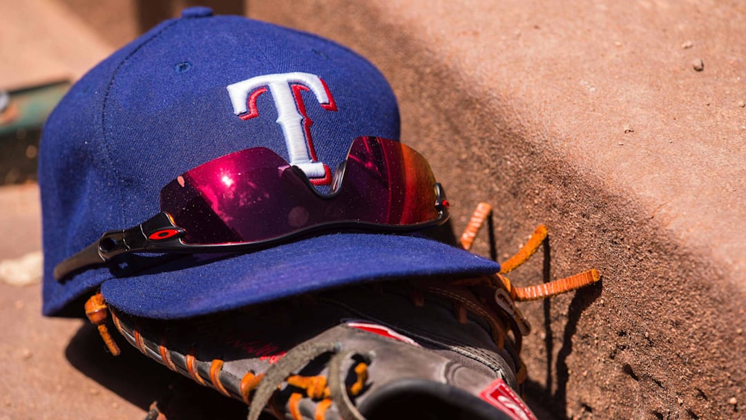 Jun 13, 2015; Arlington, TX, USA; A view a Texas Rangers baseball hat and glove during the game between the Texas Rangers and the Minnesota Twins at Globe Life Park in Arlington. The Rangers defeated the Twins 11-7. Jun 13, 2015; Arlington, TX, USA; A view a Texas Rangers baseball hat and glove during the game between the Texas Rangers and the Minnesota Twins at Globe Life Park in Arlington. The Rangers defeated the Twins 11-7.