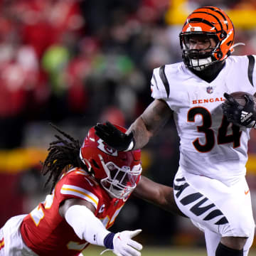 Cincinnati Bengals running back Samaje Perine (34) carries the ball as Kansas City Chiefs linebacker Nick Bolton (32) attempts a tackle in the second quarter during the AFC championship game between the Cincinnati Bengals and the Kansas City Chiefs, Sunday, Jan. 29, 2023.