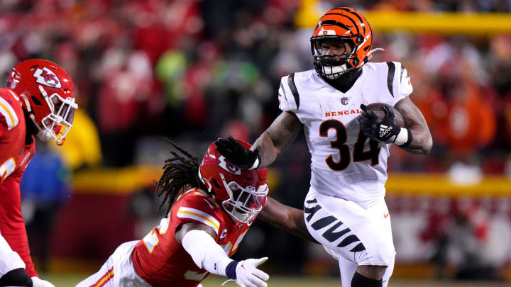 Cincinnati Bengals running back Samaje Perine (34) carries the ball as Kansas City Chiefs linebacker Nick Bolton (32) attempts a tackle in the second quarter during the AFC championship game between the Cincinnati Bengals and the Kansas City Chiefs, Sunday, Jan. 29, 2023.