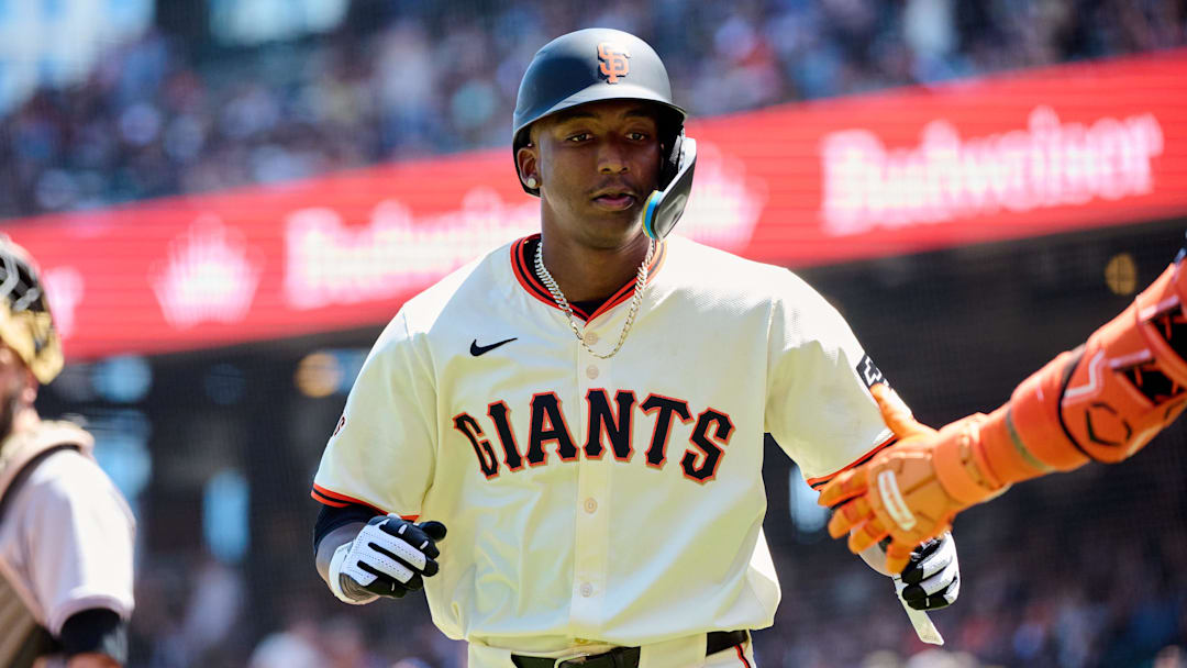 May 19, 2024; San Francisco, California, USA; San Francisco Giants infielder Marco Luciano (37) shakes hands with a teammate after scoring a run against the Colorado Rockies during the fifth inning at Oracle Park. Mandatory Credit: Robert Edwards-Imagn Images