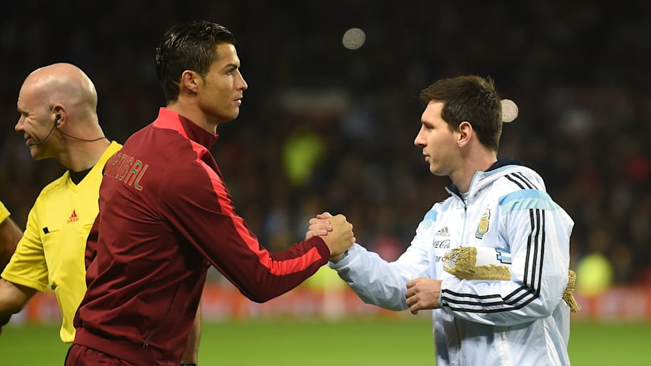 Cristiano Ronaldo (left) and Lionel Messi shaking hands.