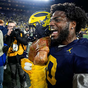 Michigan defensive end Josaiah Stewart (0) celebrates with the Paul Bunyan Trophy after 24-17 win over Michigan State at Michigan Stadium in Ann Arbor on Saturday, Oct. 26, 2024.