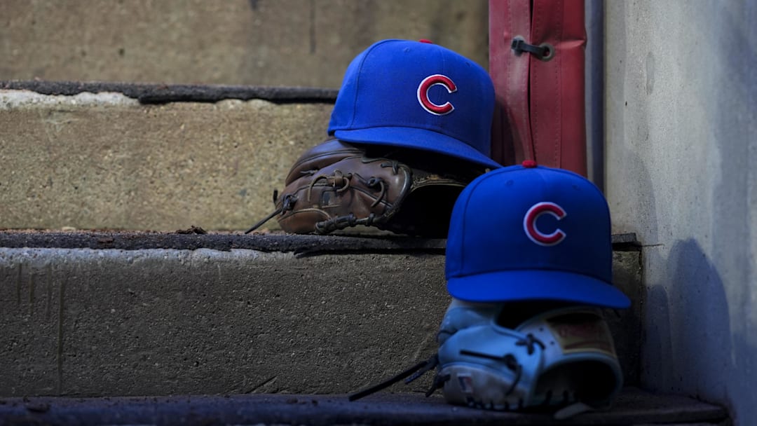 Sep 20, 2025; Cincinnati, Ohio, USA; Chicago player hats are seen on the dugout steps during the game between the Chicago Cubs and the Cincinnati Reds at Great American Ball Park. Mandatory Credit: Aaron Doster-Imagn Images