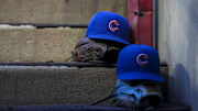 Sep 20, 2025; Cincinnati, Ohio, USA; Chicago player hats are seen on the dugout steps during the game between the Chicago Cubs and the Cincinnati Reds at Great American Ball Park. Mandatory Credit: Aaron Doster-Imagn Images