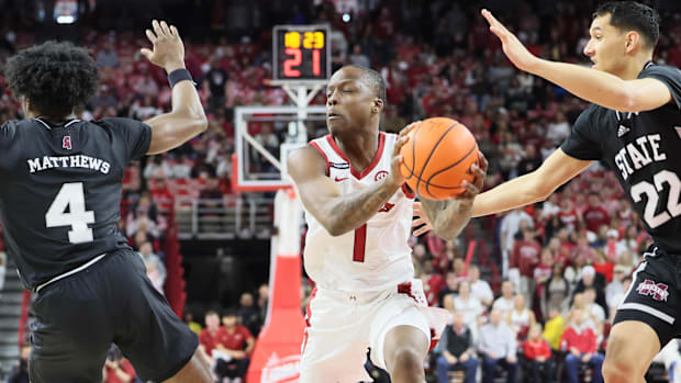 Arkansas Razorbacks guard Johnell Davis (1) drives against Mississippi State Bulldogs forward RJ Melendez (22) 