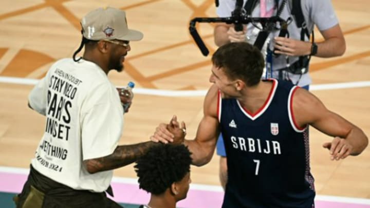 Carmelo Anthony (pictured left) and Bogdan Bogdanovic (No. 7) embrace after Serbia's 93-83 win over Germany in the bronze medal game at Bercy Arena in the 2024 Paris Olympics on Saturday, August 10. 