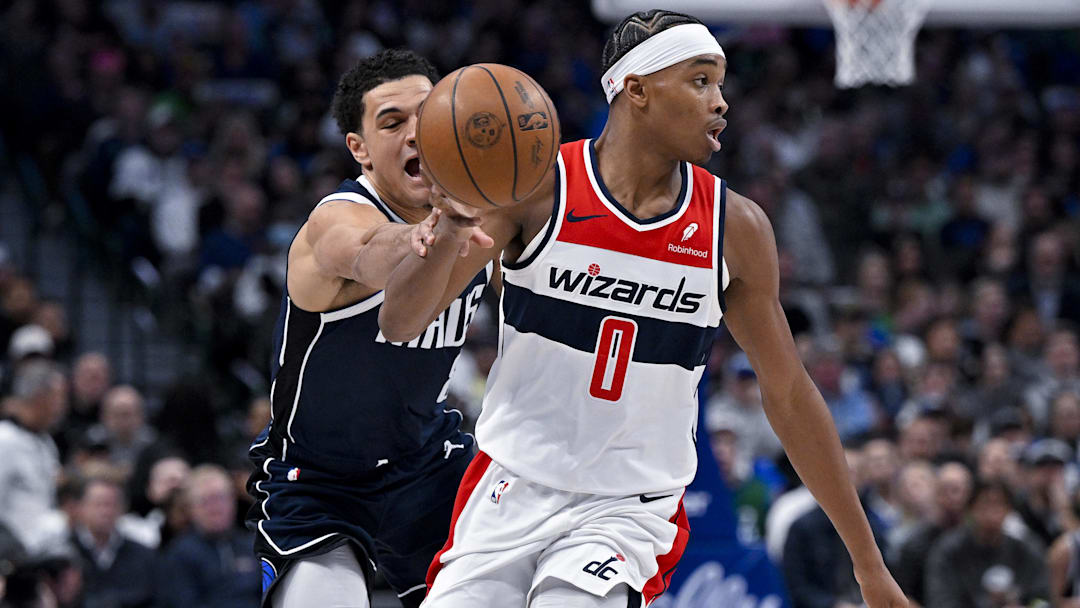 Feb 12, 2024; Dallas, Texas, USA; Dallas Mavericks guard Josh Green (8) knocks the ball away from Washington Wizards guard Bilal Coulibaly (0) during the second quarter at the American Airlines Center. Mandatory Credit: Jerome Miron-Imagn Images