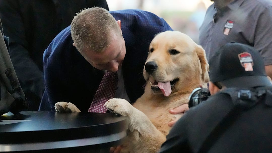 Oct. 4, 2025; Tuscaloosa, Alabama, USA; Kirk Herbstreit gives some love to his dog, Peter, during ESPN’s College GameDay on location on the Quad at the University of Alabama.