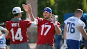 Bills quarterback Josh Allen works on his pre-game unique handshake with teammate Mike White.