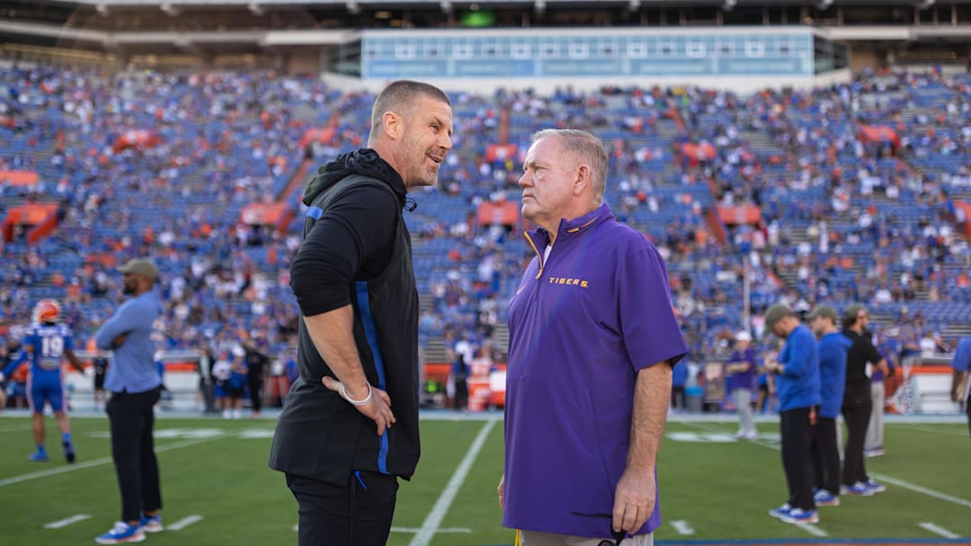 Nov 16, 2024; Gainesville, Florida, USA; Florida Gators head coach Billy Napier and LSU Tigers head coach Brian Kelly talk midfield before a game at Ben Hill Griffin Stadium. Mandatory Credit: Matt Pendleton-Imagn Images