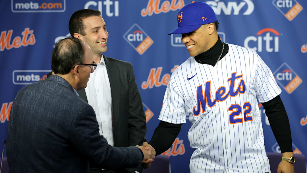 Dec 12, 2024; Flushing, NY, USA; New York Mets right fielder Juan Soto shakes hands with team owner Steve Cohen in front of general manager David Stearns during a press conference at Citi Field. Mandatory Credit: Brad Penner-Imagn Images