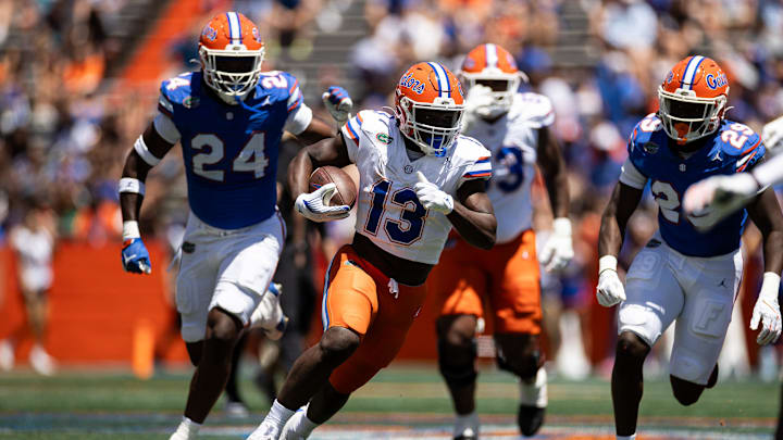 Florida Gators running back Jadan Baugh (13) rushes with the ball during the first half at the Orange and Blue spring football game at Steve Spurrier Field at Ben Hill Griffin Stadium in Gainesville, FL on Saturday, April 13, 2024. [Matt Pendleton/Gainesville Sun]