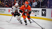 Mar 1, 2025; Anaheim, California, USA; Anaheim Ducks left wing Cutter Gauthier (61) moves the puck ahead of Chicago Blackhawks defenseman Wyatt Kaiser (44) during the second period at Honda Center. Mandatory Credit: Gary A. Vasquez-Imagn Images