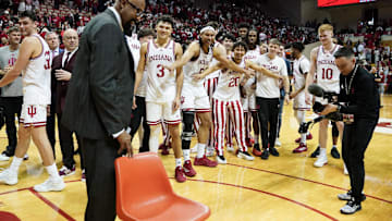 Feb 23, 2025; Bloomington, Indiana, USA; Indiana Hoosiers head coach Mike Woodson and his players stand near a chair after the game against the Purdue Boilermakers at Simon Skjodt Assembly Hall. Mandatory Credit: Robert Goddin-Imagn Images