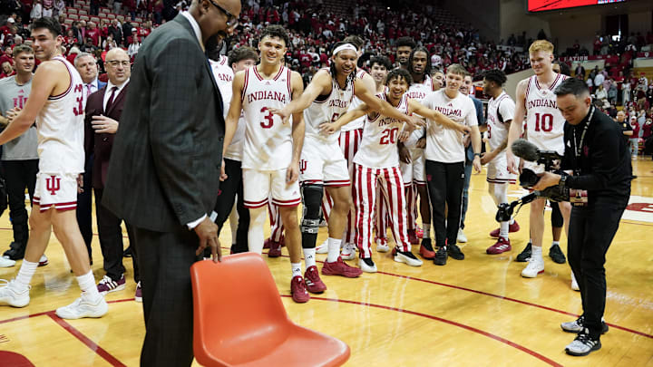 Feb 23, 2025; Bloomington, Indiana, USA; Indiana Hoosiers head coach Mike Woodson and his players stand near a chair after the game against the Purdue Boilermakers at Simon Skjodt Assembly Hall. Mandatory Credit: Robert Goddin-Imagn Images