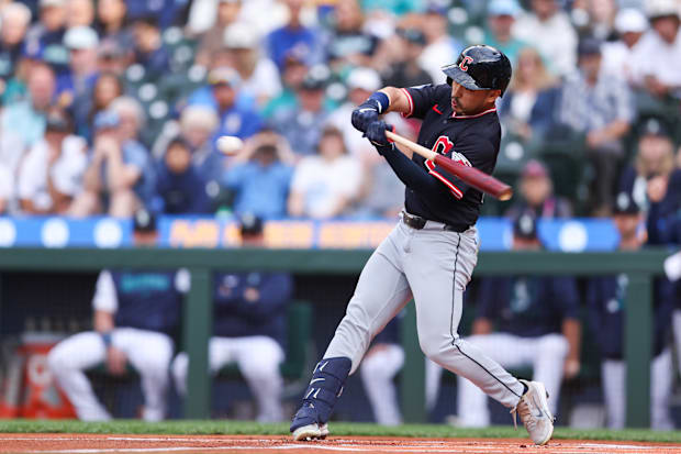 Steven Kwan swings at a ball 