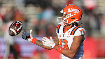 Nov 23, 2024; Piscataway, New Jersey, USA; Illinois Fighting Illini wide receiver Pat Bryant (13) attempts to male a catch during the second half against the Rutgers Scarlet Knights at SHI Stadium. Mandatory Credit: Vincent Carchietta-Imagn Images