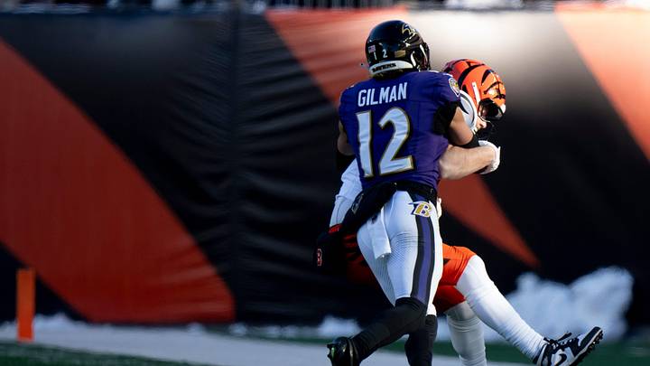 Baltimore Ravens safety Alohi Gilman (12) tackles Cincinnati Bengals tight end Tanner Hudson (87) in the third quarter of the NFL football game at Paycor Stadium in Cincinnati on Dec. 14, 2025.