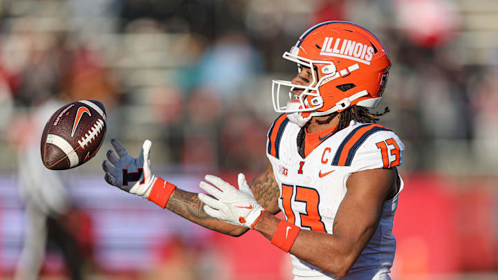 Nov 23, 2024; Piscataway, New Jersey, USA; Illinois Fighting Illini wide receiver Pat Bryant (13) attempts to male a catch during the second half against the Rutgers Scarlet Knights at SHI Stadium. Mandatory Credit: Vincent Carchietta-Imagn Images