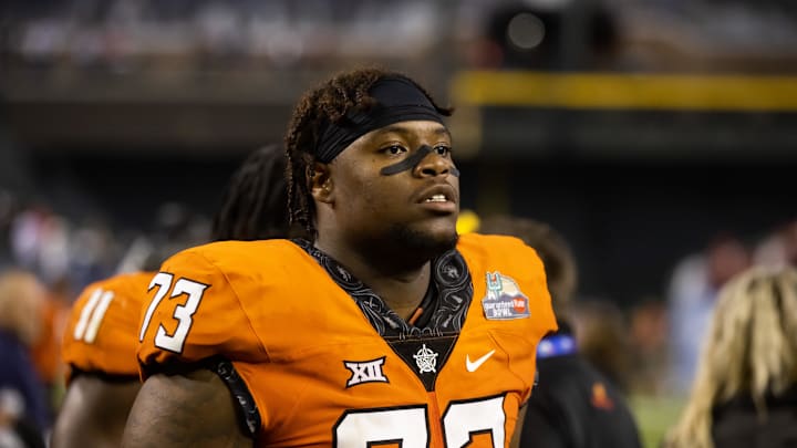 Dec 27, 2022; Phoenix, Arizona, USA; Oklahoma State Cowboys offensive lineman Jason Brooks Jr. (73) against the Wisconsin Badgers during the 2022 Guaranteed Rate Bowl at Chase Field. Mandatory Credit: Mark J. Rebilas-Imagn Images