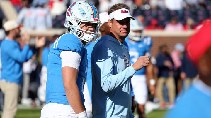 Nov 4, 2023; Oxford, Mississippi, USA; Mississippi Rebels quarterback Jaxson Dart (2) and head coach Lane Kiffin (right) talk during warm ups prior to the game against the Texas A&M Aggies at Vaught-Hemingway Stadium. Mandatory Credit: Petre Thomas-USA TODAY Sports