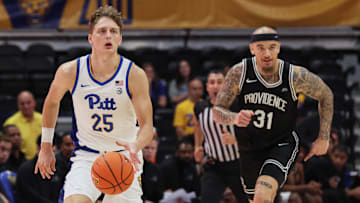 Oct 19, 2025; Pittsburgh, PA, USA;  Pittsburgh Panthers guard Nojus Indrusaitis (25) brings the ball up court against Providence Friars forward Duncan Powell (31) during the second half at the Petersen Events Center. Mandatory Credit: Charles LeClaire-Imagn Images