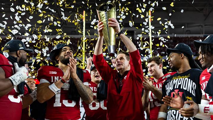 Jan 19, 2026; Miami Gardens, FL, USA; Indiana Hoosiers head coach Curt Cignetti hoists the trophy as he celebrates after defeating the Miami Hurricanes in the College Football Playoff National Championship game at Hard Rock Stadium. Mandatory Credit: Mark J. Rebilas-Imagn Images