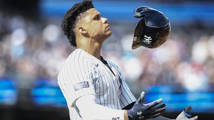 Sep 1, 2024; Bronx, New York, USA;  New York Yankees right fielder Juan Soto (22) tosses his helmet after flying out to end the sixth inning against the St. Louis Cardinals at Yankee Stadium.