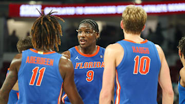 Feb 11, 2025; Starkville, Mississippi, USA; Florida Gators center Rueben Chinyelu (9) talks to guard Denzel Aberdeen (11) and forward Thomas Haugh (10) during the second half against the Mississippi State Bulldogs at Humphrey Coliseum. Mandatory Credit: Wesley Hale-Imagn Images