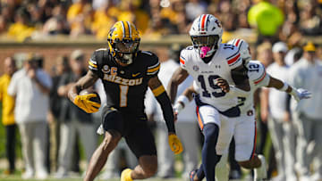 Oct 19, 2024; Columbia, Missouri, USA; Missouri Tigers wide receiver Theo Wease Jr. (1) runs with the ball against Auburn Tigers safety Sylvester Smith (19) during the first half at Faurot Field at Memorial Stadium. Mandatory Credit: Jay Biggerstaff-Imagn Images