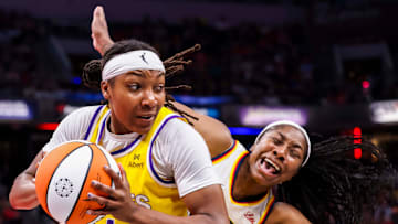 Los Angeles Sparks forward Liatu King (4) grabs the ball while Indiana Fever guard Aari McDonald (2) falls back Thursday, June 26, 2025, during a game between the Indiana Fever and the Los Angeles Sparks at Gainbridge Fieldhouse in Indianapolis.