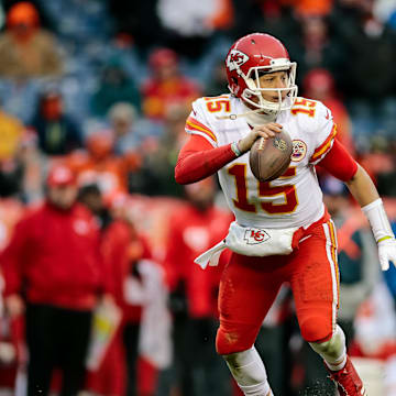 Dec 31, 2017; Denver, CO, USA; Kansas City Chiefs quarterback Patrick Mahomes (15) scrambles in the back field against the Denver Broncos at Sports Authority Field at Mile High. Mandatory Credit: Isaiah J. Downing-Imagn Images