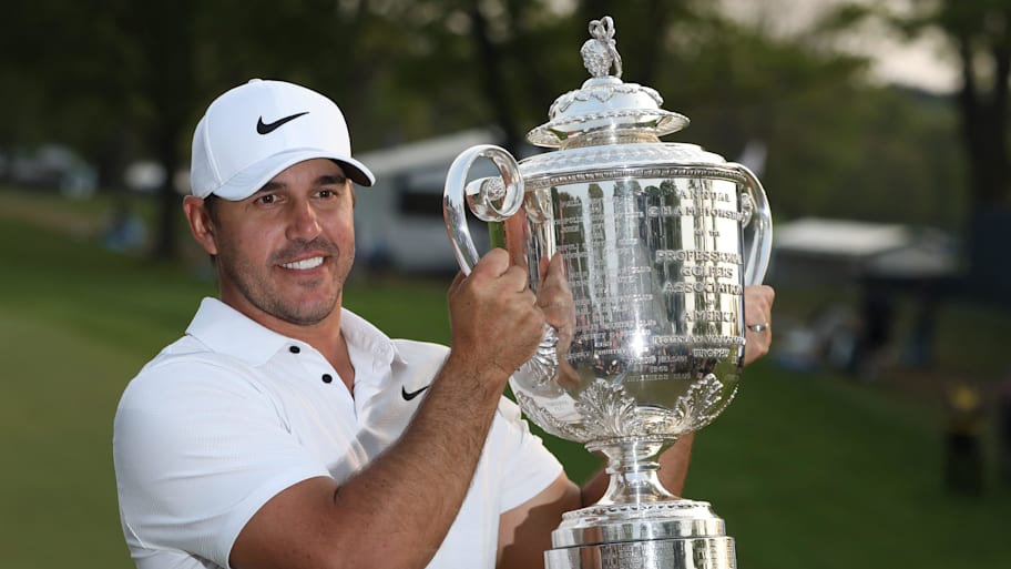 Brooks Koepka poses with the Wanamaker Trophy on the 18th green following his victory at the PGA Championship at Oak Hill.