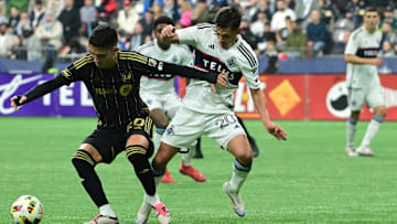 Nov 3, 2024; Vancouver, British Columbia, CAN; LAFC midfielder Eduard Atuesta (20) plays the ball with Vancouver Whitecaps midfielder Andrés Cubas (20) in the second half in a 2024 MLS Cup Playoffs Round One match at BC Place. Mandatory Credit: Anne-Marie Sorvin-Imagn Images