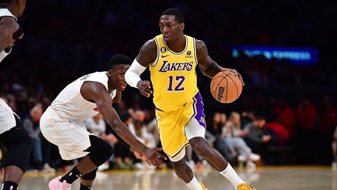 Jan 4, 2023; Los Angeles, California, USA; Los Angeles Lakers guard Kendrick Nunn (12) moves the ball ahead of Miami Heat guard Victor Oladipo (4) during the second half at Crypto.com Arena.