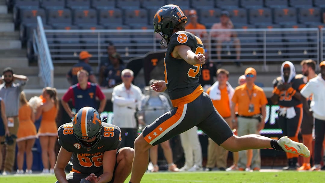 Tennessee punter/place kicker Josh Turbyville (94) kicks a field goal as Tennessee punter Jackson Ross (98) holds the ball during a football game between Tennessee and Chattanooga at Neyland Stadium in Knoxville, Tenn., on Saturday, August 31, 2024.