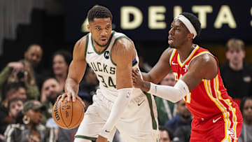 Mar 4, 2025; Atlanta, Georgia, USA; Milwaukee Bucks forward Giannis Antetokounmpo (34) controls the ball against Atlanta Hawks forward Onyeka Okongwu (17) during the second half at State Farm Arena. Mandatory Credit: Dale Zanine-Imagn Images