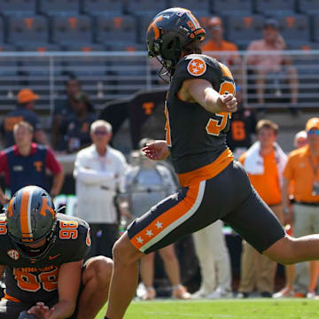 Tennessee punter/place kicker Josh Turbyville (94) kicks a field goal as Tennessee punter Jackson Ross (98) holds the ball during a football game between Tennessee and Chattanooga at Neyland Stadium in Knoxville, Tenn., on Saturday, August 31, 2024.