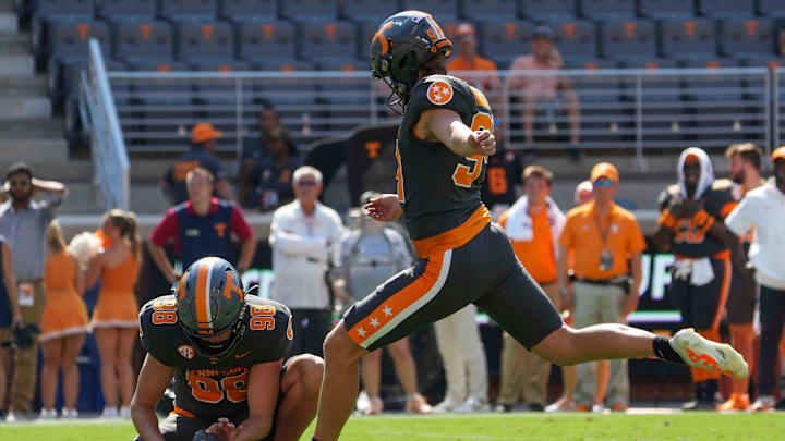 Tennessee punter/place kicker Josh Turbyville (94) kicks a field goal as Tennessee punter Jackson Ross (98) holds the ball during a football game between Tennessee and Chattanooga at Neyland Stadium in Knoxville, Tenn., on Saturday, August 31, 2024.