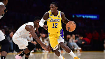Jan 4, 2023; Los Angeles, California, USA; Los Angeles Lakers guard Kendrick Nunn (12) moves the ball ahead of Miami Heat guard Victor Oladipo (4) during the second half at Crypto.com Arena.