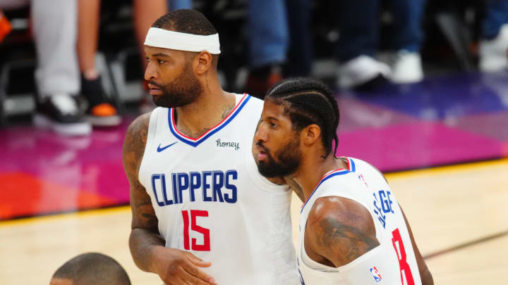 Los Angeles Clippers guard Paul George (13) and center DeMarcus Cousins (15) against the Phoenix Suns in game five of the Western Conference Finals for the 2021 NBA Playoffs at Phoenix Suns Arena. Mandatory Credit: 