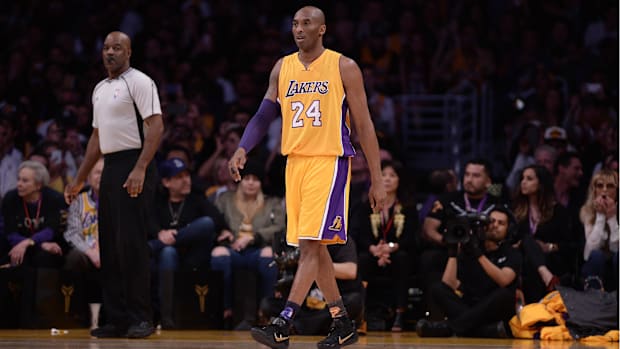 Kobe Bryant (24) walks on the field against Utah Jazz during the first quarter at Staples Center