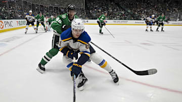 Dec 14, 2024; Dallas, Texas, USA; Dallas Stars defenseman Ilya Lyubushkin (46) and St. Louis Blues left wing Dylan Holloway (81) in action during the game between the Dallas Stars and the St. Louis Blues at American Airlines Center. Mandatory Credit: Jerome Miron-Imagn Images